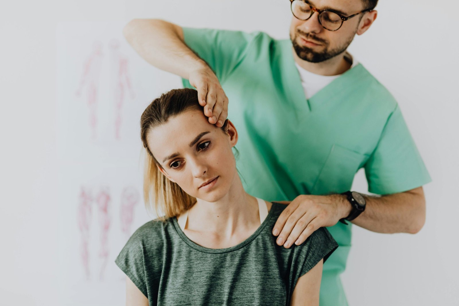 A chiropractor performs therapeutic neck adjustments on a patient for pain relief.